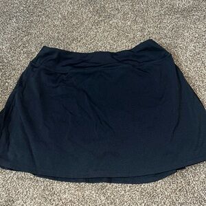 Black tennis skirt with pleated back.